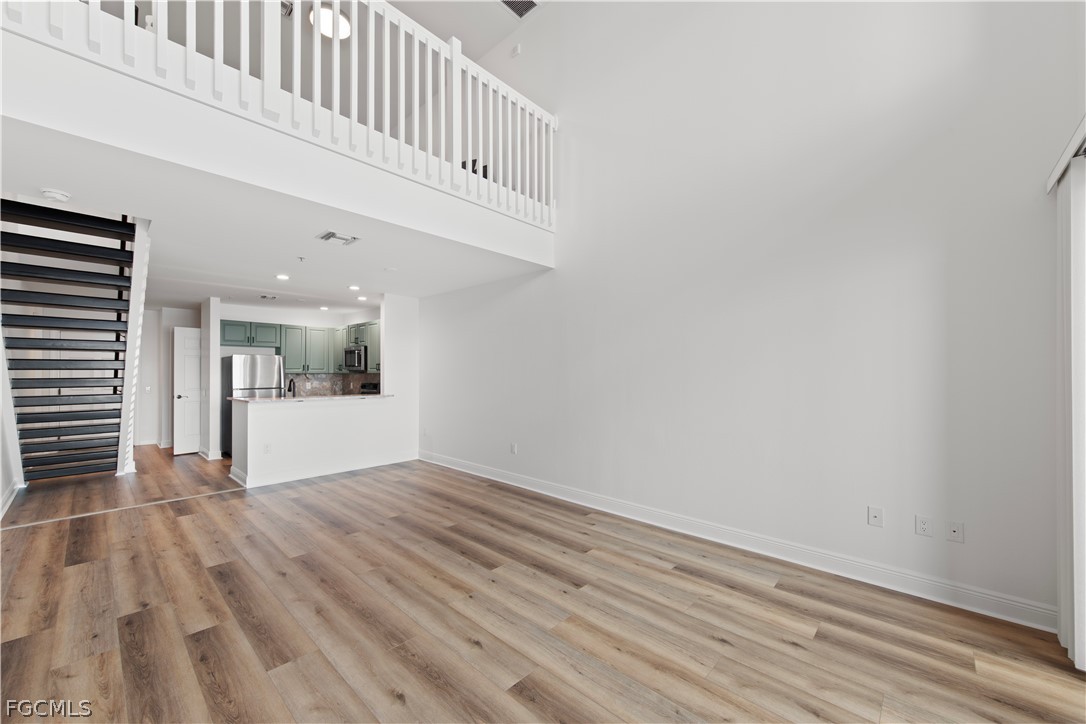 2745 First Street, Unit 113 Fort Myers, FL 33916 - Photo 12 of 35 a view of a hallway with wooden floor and staircase