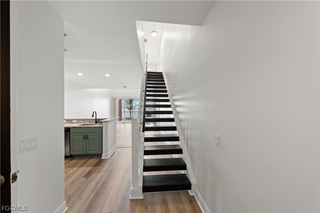 2745 First Street, Unit 113 Fort Myers, FL 33916 - Photo 14 of 35 a view of entryway and hall with wooden floor