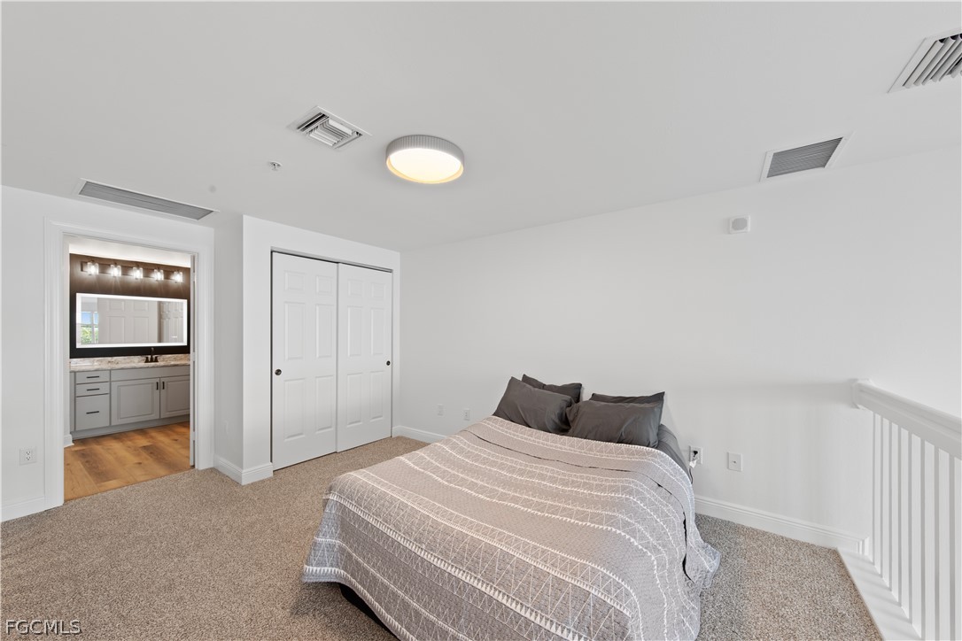2745 First Street, Unit 113 Fort Myers, FL 33916 - Photo 15 of 35 a bedroom with a bed and cabinets