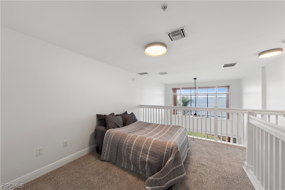 2745 First Street, Unit 113 Fort Myers, FL 33916 - Photo 16 of 35 a bedroom with a bed and cabinets