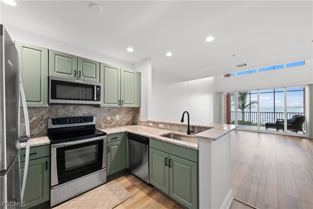 2745 First Street, Unit 113 Fort Myers, FL 33916 - Photo 4 of 35 a kitchen with a sink stove and microwave