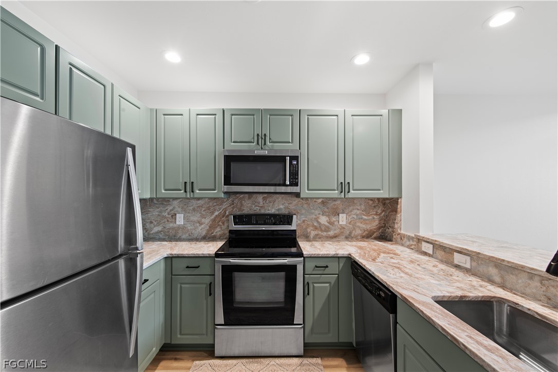 2745 First Street, Unit 113 Fort Myers, FL 33916 - Photo 5 of 35 a kitchen with a sink stove and refrigerator