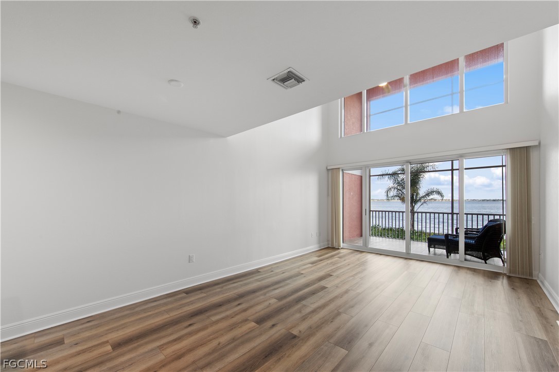 2745 First Street, Unit 113 Fort Myers, FL 33916 - Photo 9 of 35 a view of empty room with wooden floor and fan