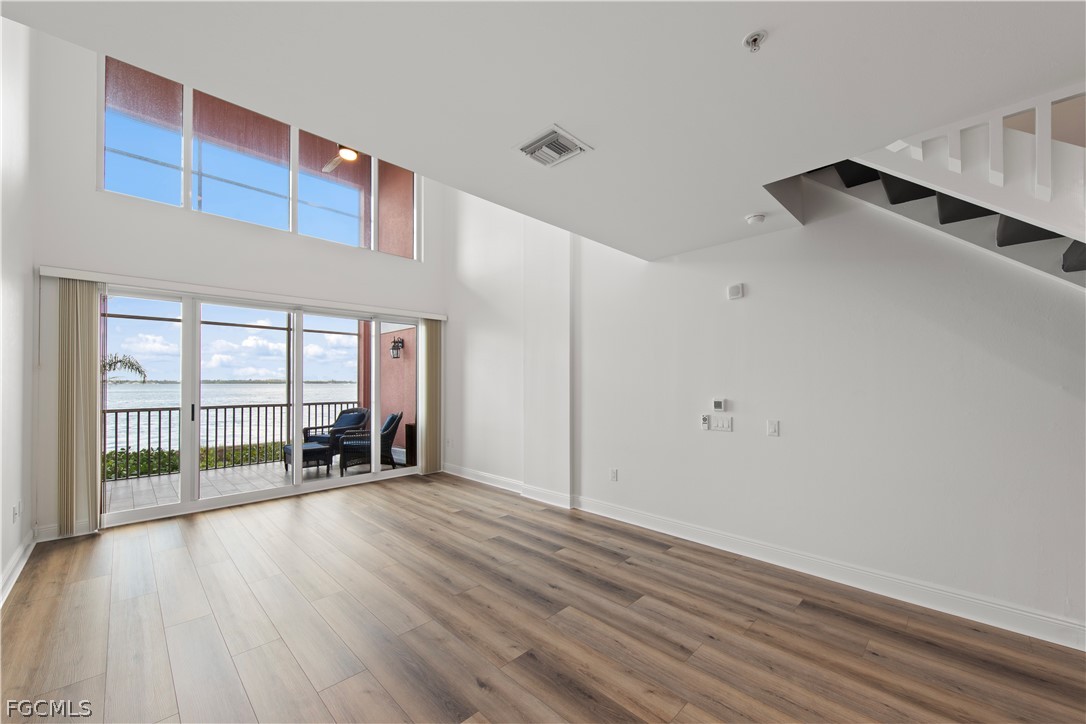 2745 First Street, Unit 113 Fort Myers, FL 33916 - Photo 10 of 35 wooden floor in an empty room with a window