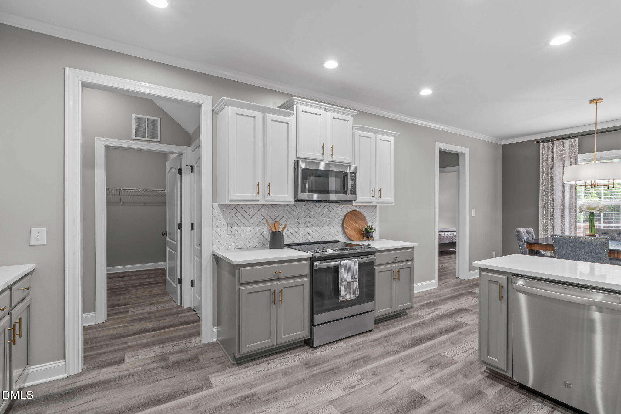 2450 Rolling Tracks Road Willow Spring, NC 27592 - Photo 23 of 64 a kitchen with a sink stove and cabinets