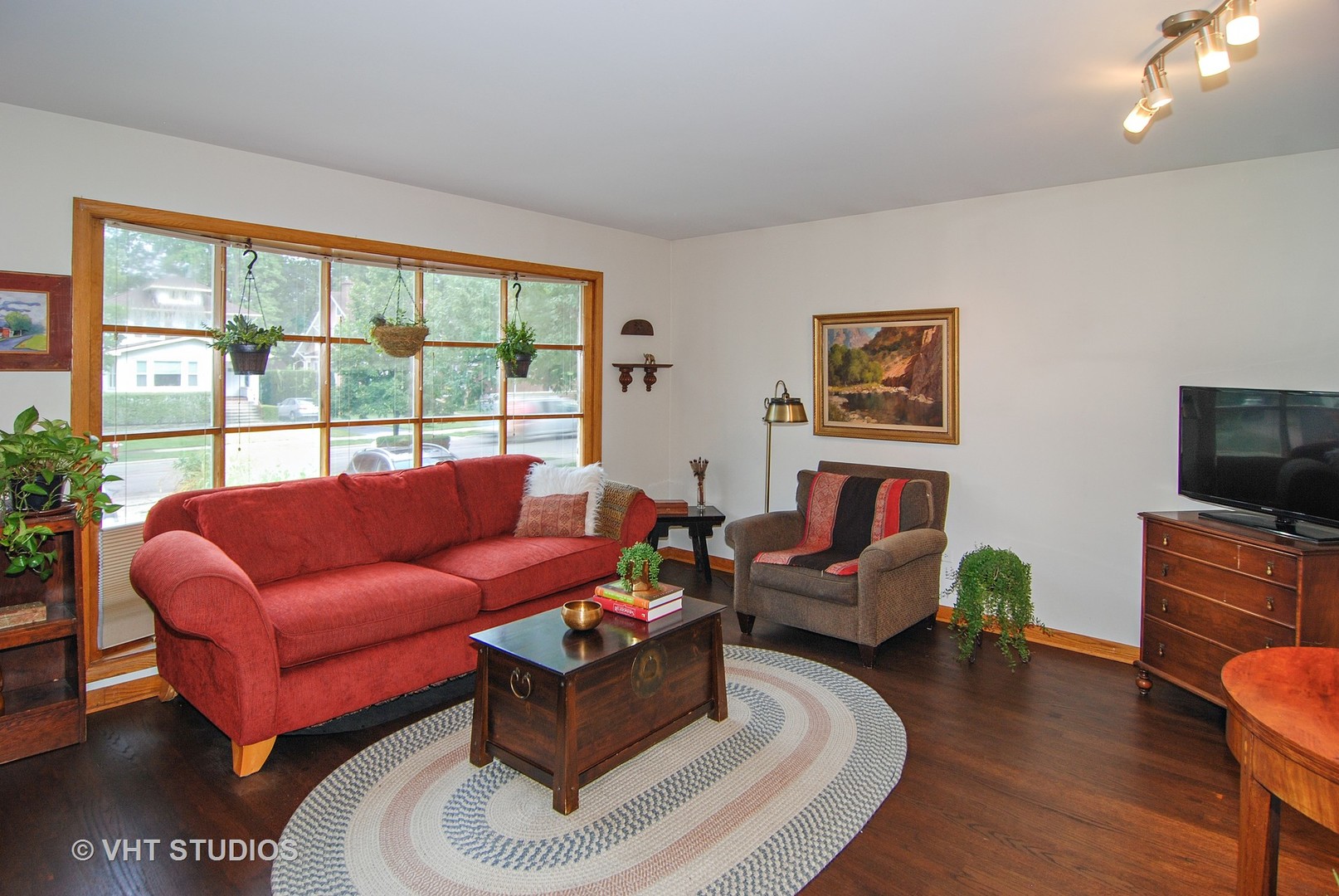 141 Barrypoint Road Riverside, IL 60546 - Photo 2 of 19 a living room with furniture a flat screen tv and a large window