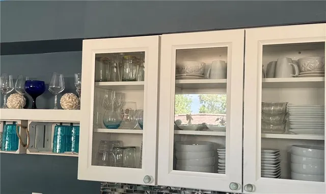 a kitchen with granite countertop a stove a sink and a refrigerator