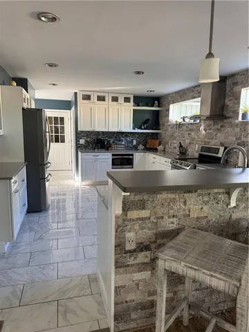a kitchen with stainless steel appliances granite countertop a stove and a sink