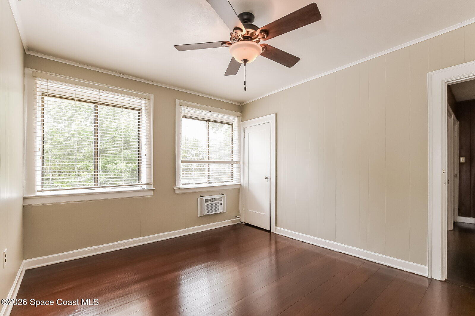 1428 Riverside Drive Titusville, FL 32780 - Photo 12 of 17 a view of an empty room with wooden floor and a window