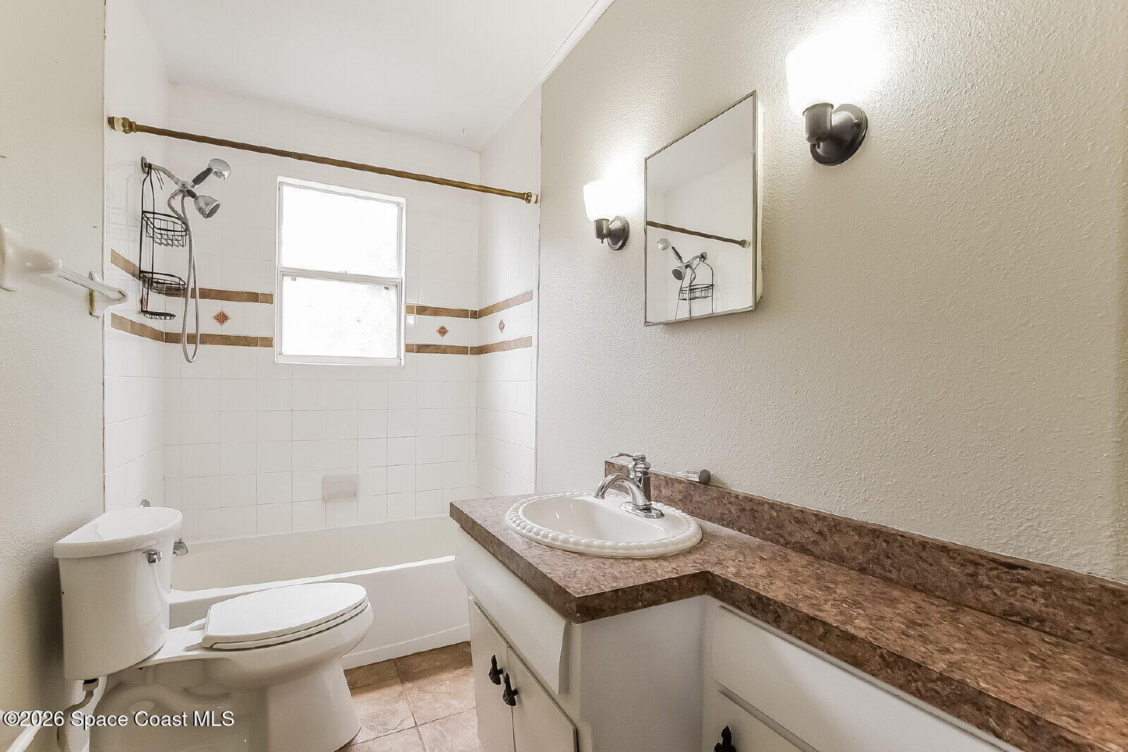 1428 Riverside Drive Titusville, FL 32780 - Photo 14 of 17 a bathroom with a granite countertop sink toilet and a mirror