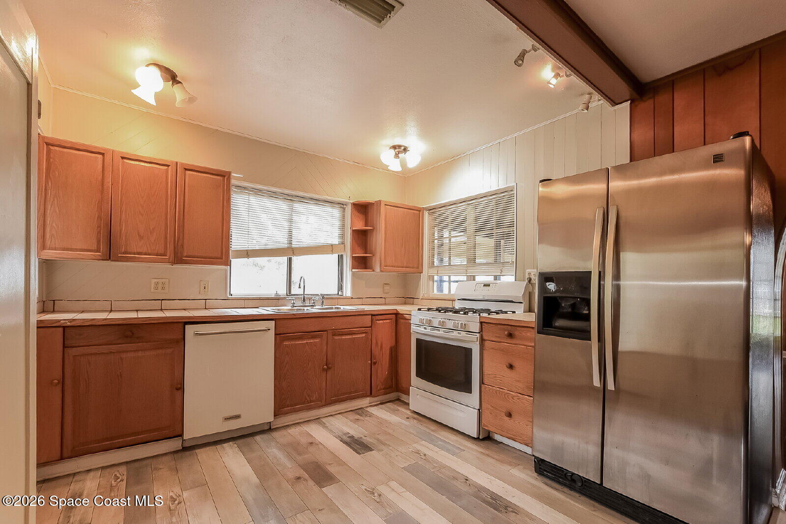 1428 Riverside Drive Titusville, FL 32780 - Photo 6 of 17 a kitchen with stainless steel appliances granite countertop a stove a refrigerator and a sink