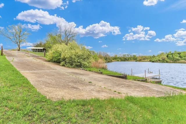 a view of a lake with houses in the back