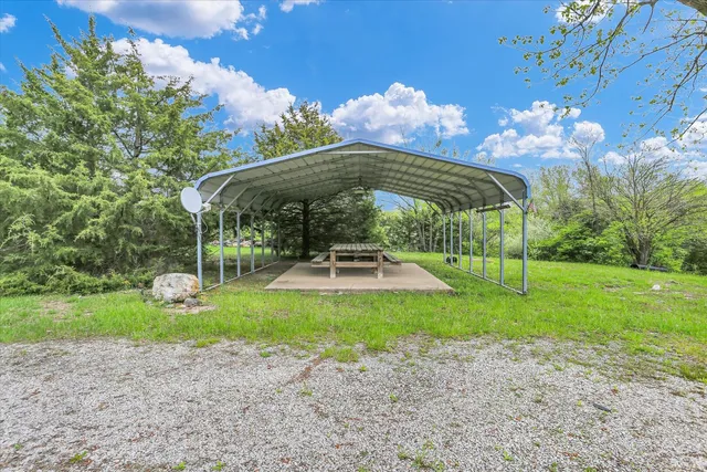 a backyard of a house with table and chairs