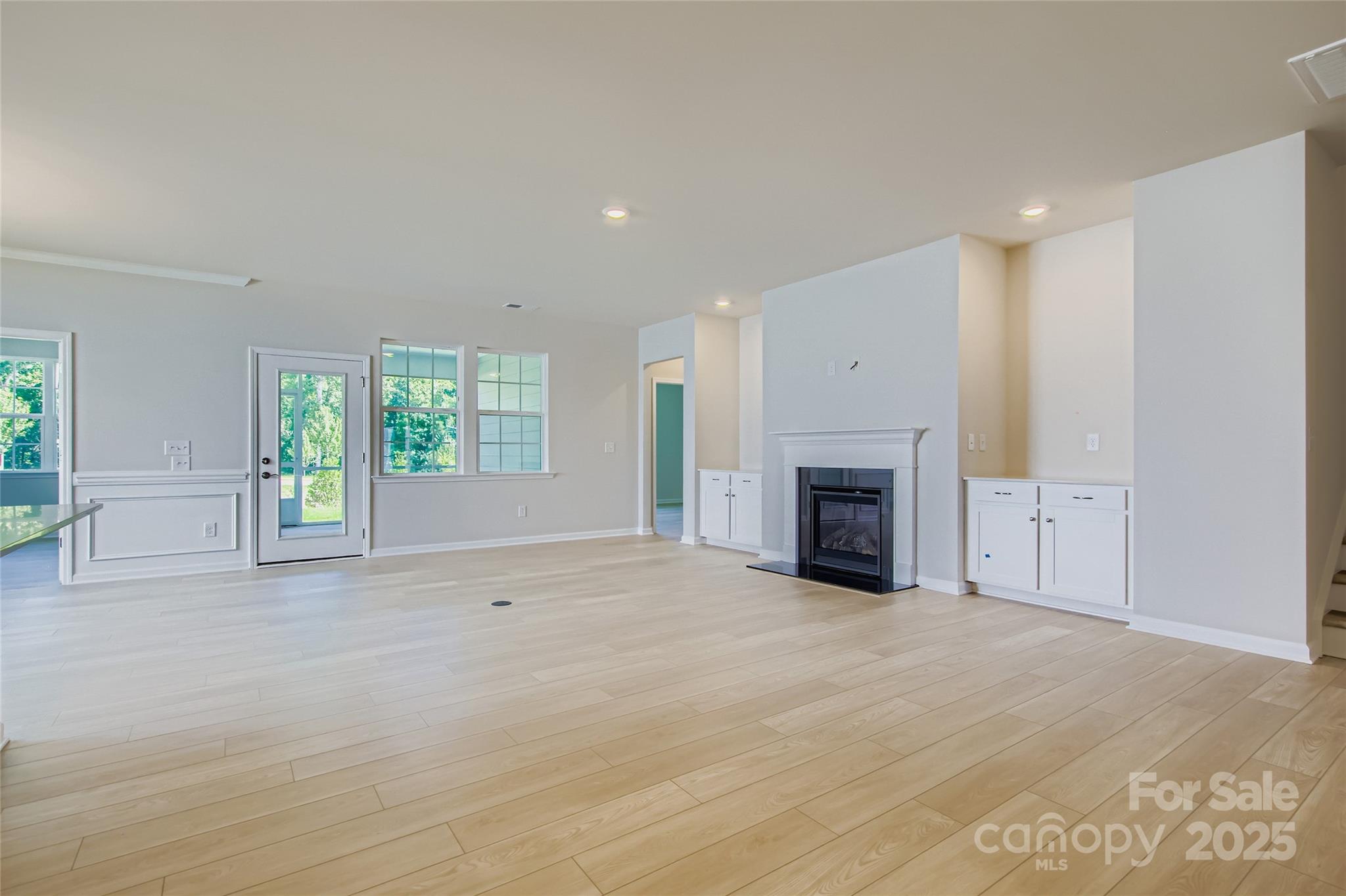2844 Morning Song Way Lancaster, SC 29720 - Photo 3 of 16 an empty room with windows and fireplace