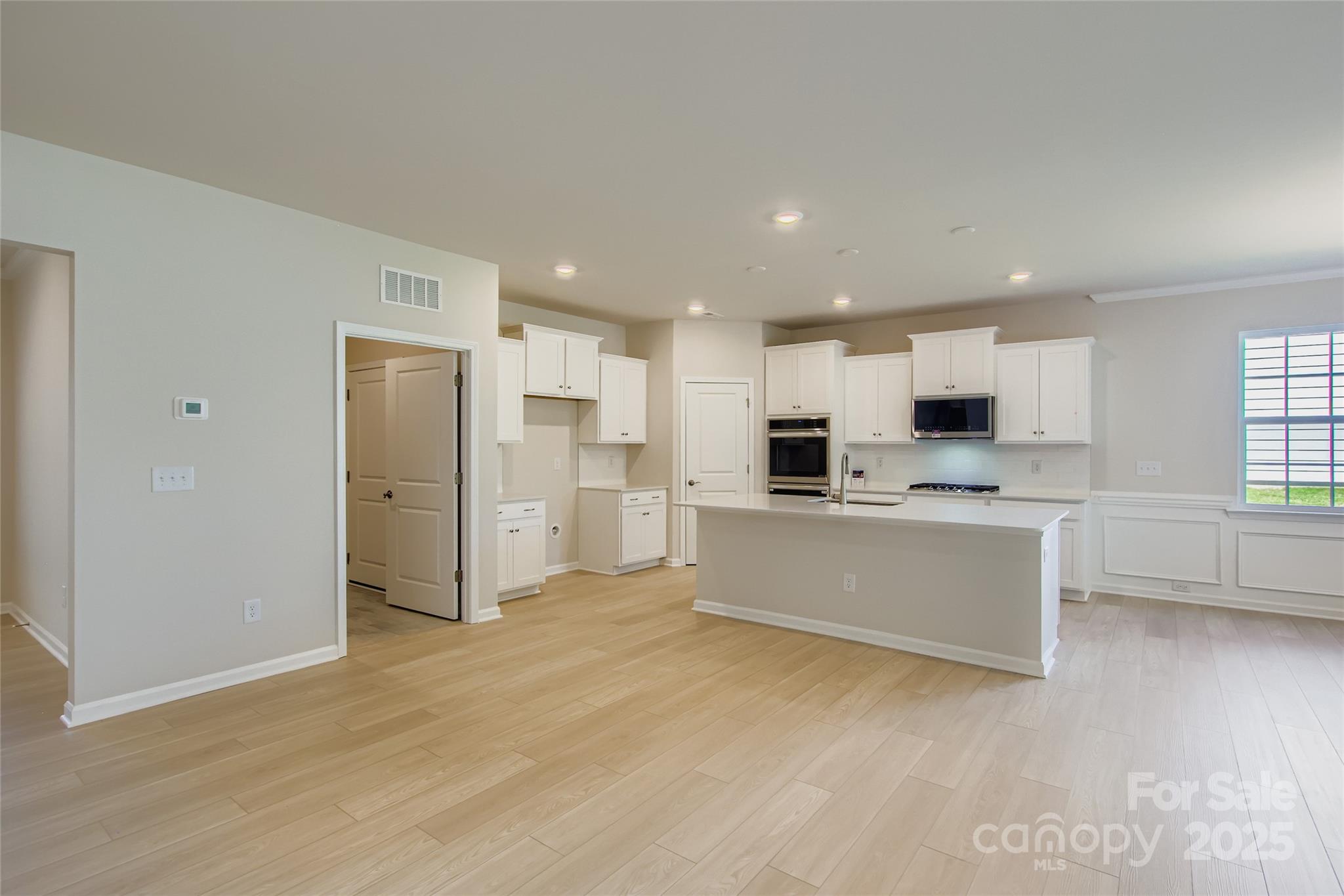 2844 Morning Song Way Lancaster, SC 29720 - Photo 4 of 16 a large kitchen with stainless steel appliances refrigerator a stove top oven and white cabinets