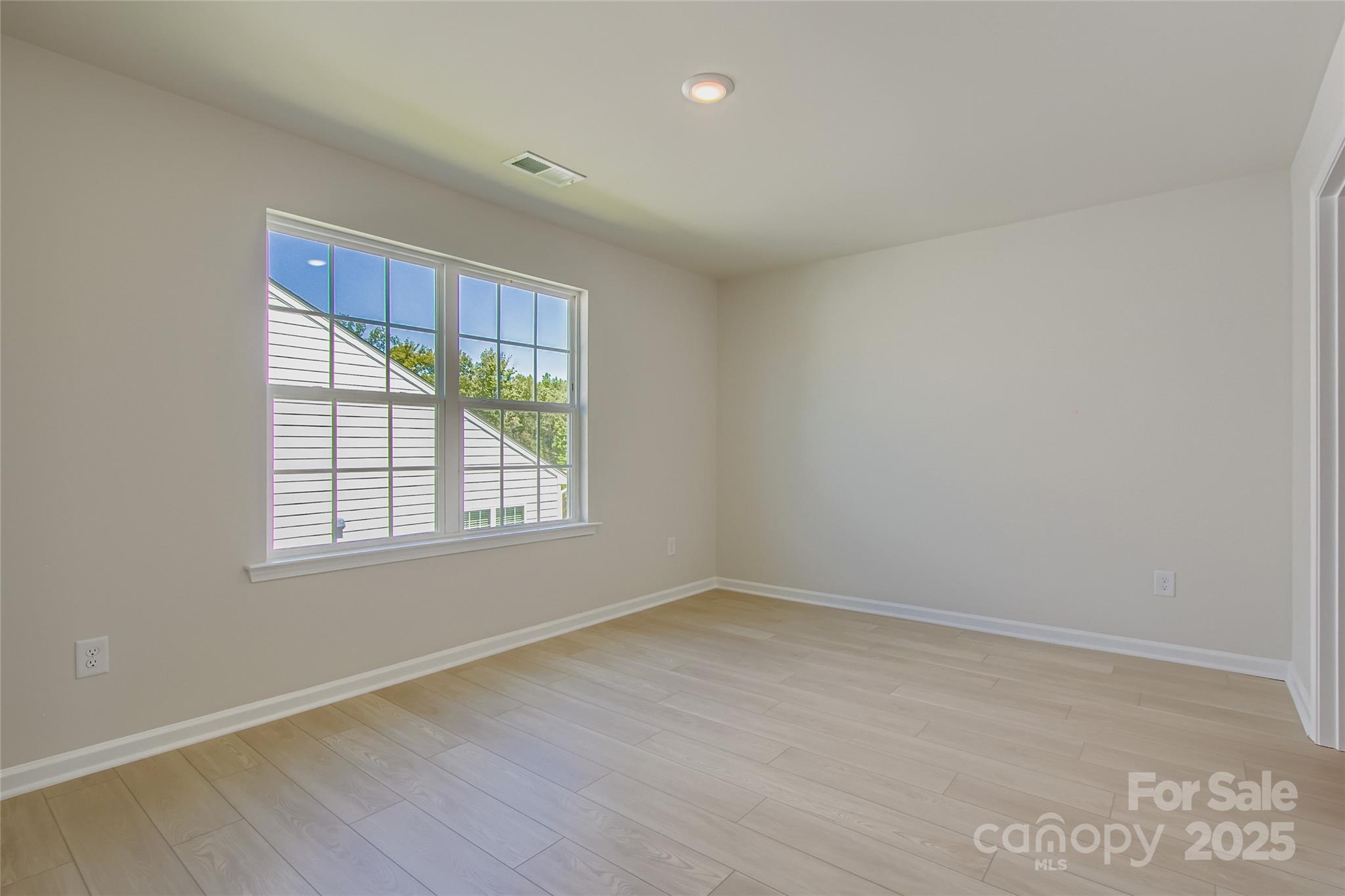 2844 Morning Song Way Lancaster, SC 29720 - Photo 10 of 16 an empty room with wooden floor and windows