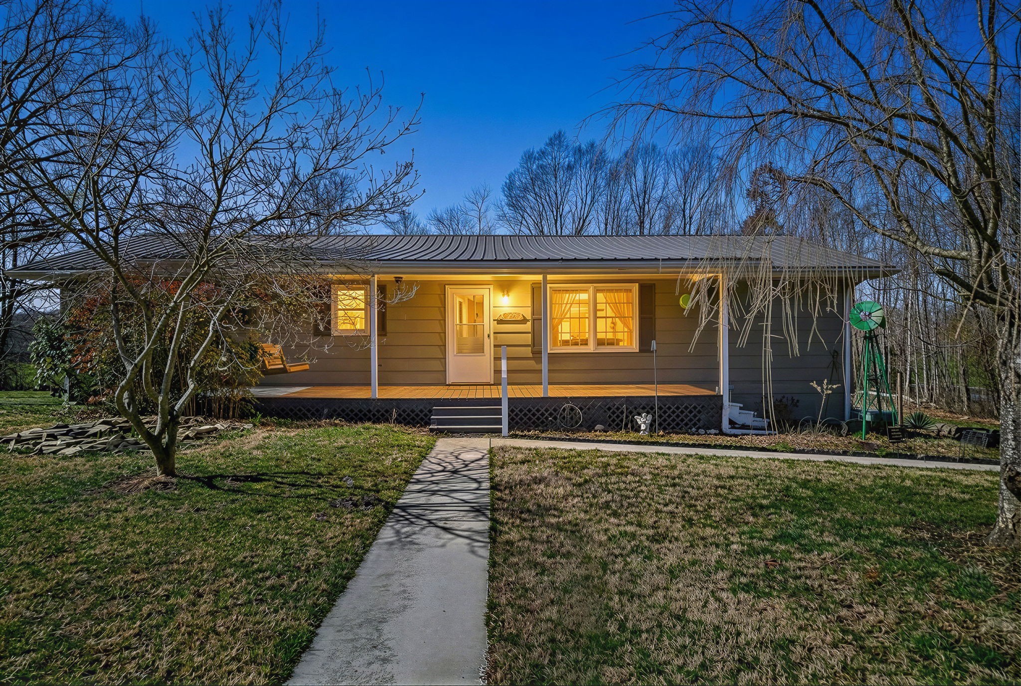 a house view with swimming pool in front of it