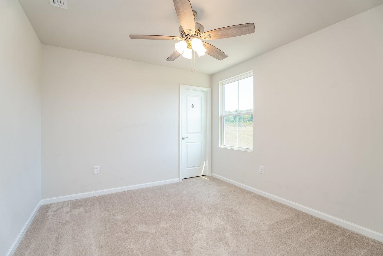 1207 Watson Lane Grottoes, VA 24441 - Photo 35 of 75 an empty room with a chandelier fan and windows