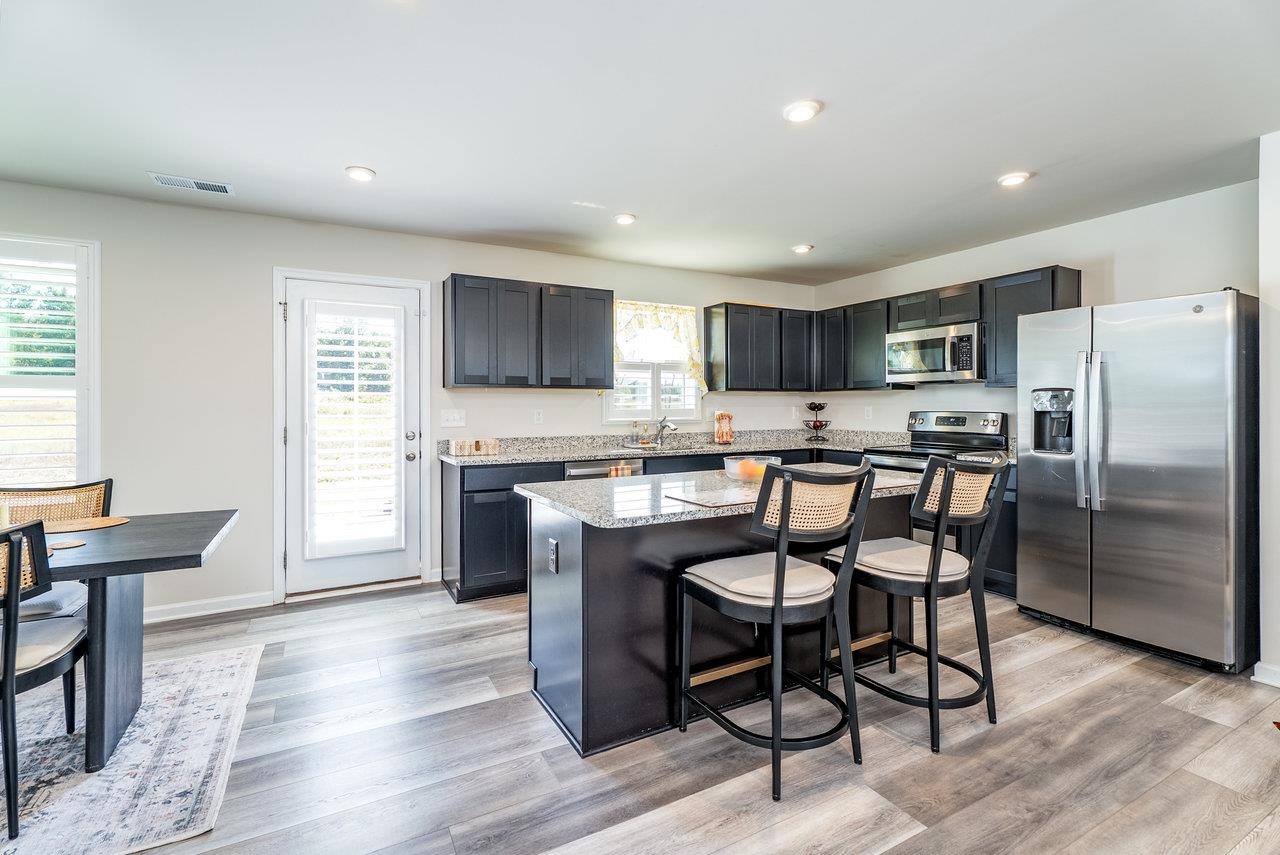 1207 Watson Lane Grottoes, VA 24441 - Photo 58 of 75 a kitchen with stainless steel appliances granite countertop a stove a sink a refrigerator with a dining table and chairs