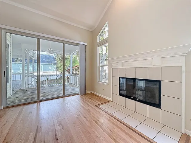 a living room with a fireplace and a floor to ceiling window
