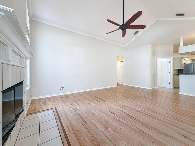 a view of a livingroom with a ceiling fan a ceiling fan and wooden floor