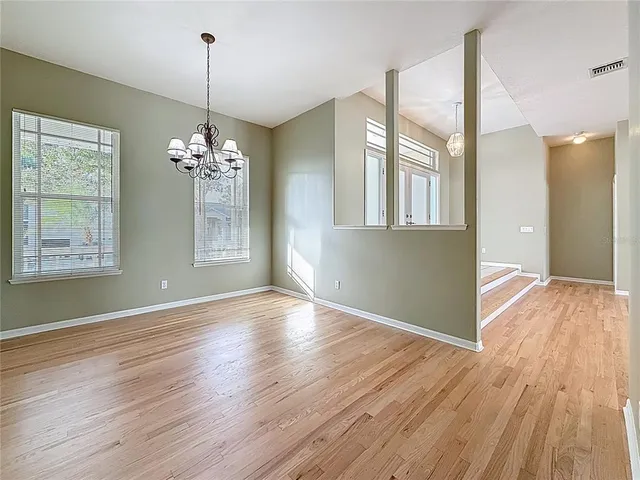 a view of livingroom with chandelier and wooden floor