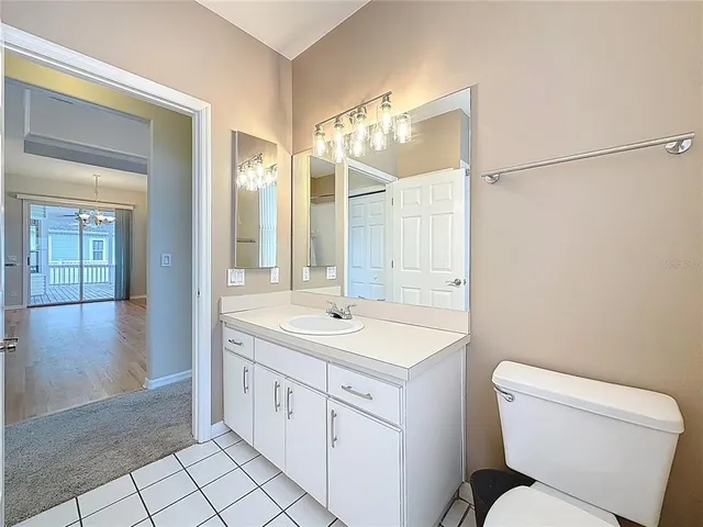 a spacious bathroom with a toilet sink and mirror