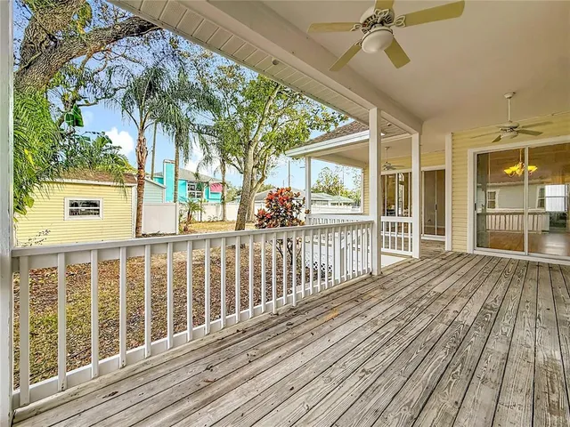 a view of a porch with wooden floor and fence
