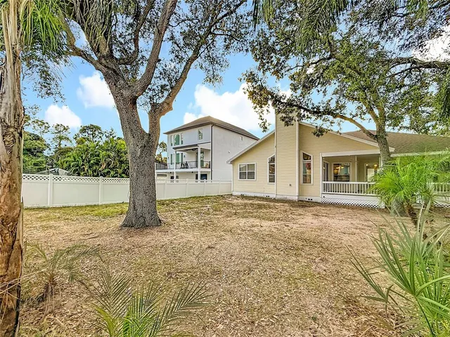 a view of a house with a tree in the yard