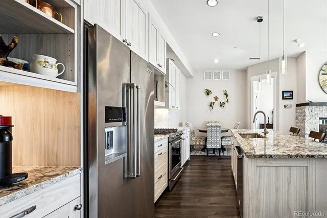 a kitchen with stainless steel appliances granite countertop a refrigerator and a sink