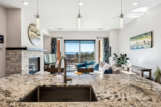 a view of a kitchen with granite countertop a fireplace