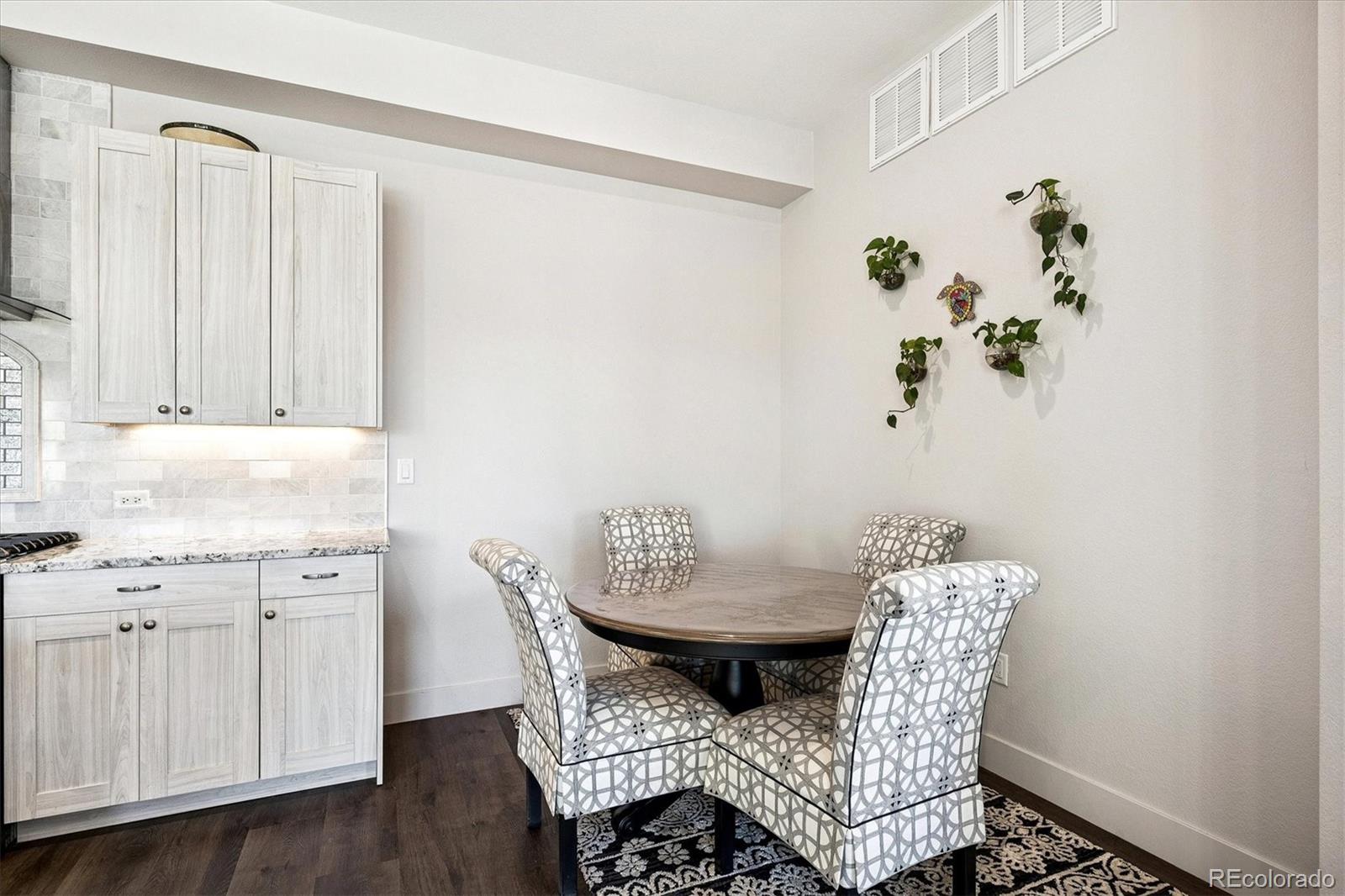 4885 South Monaco Street, Unit 207 Denver, CO 80237 - Photo 20 of 33 a view of a dining room with furniture and wooden floor