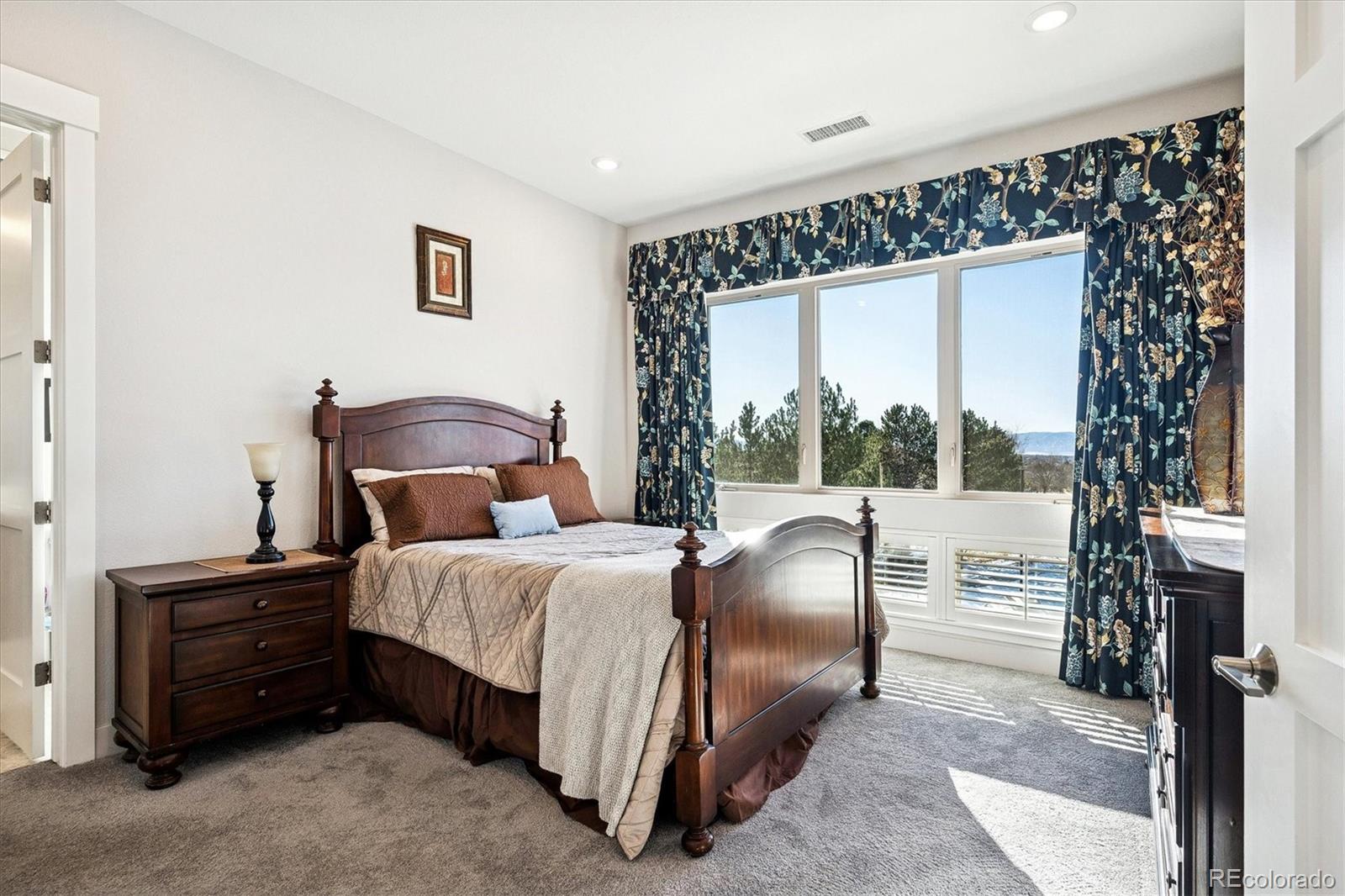 4885 South Monaco Street, Unit 207 Denver, CO 80237 - Photo 21 of 33 a bedroom with a bed lamp and a large window