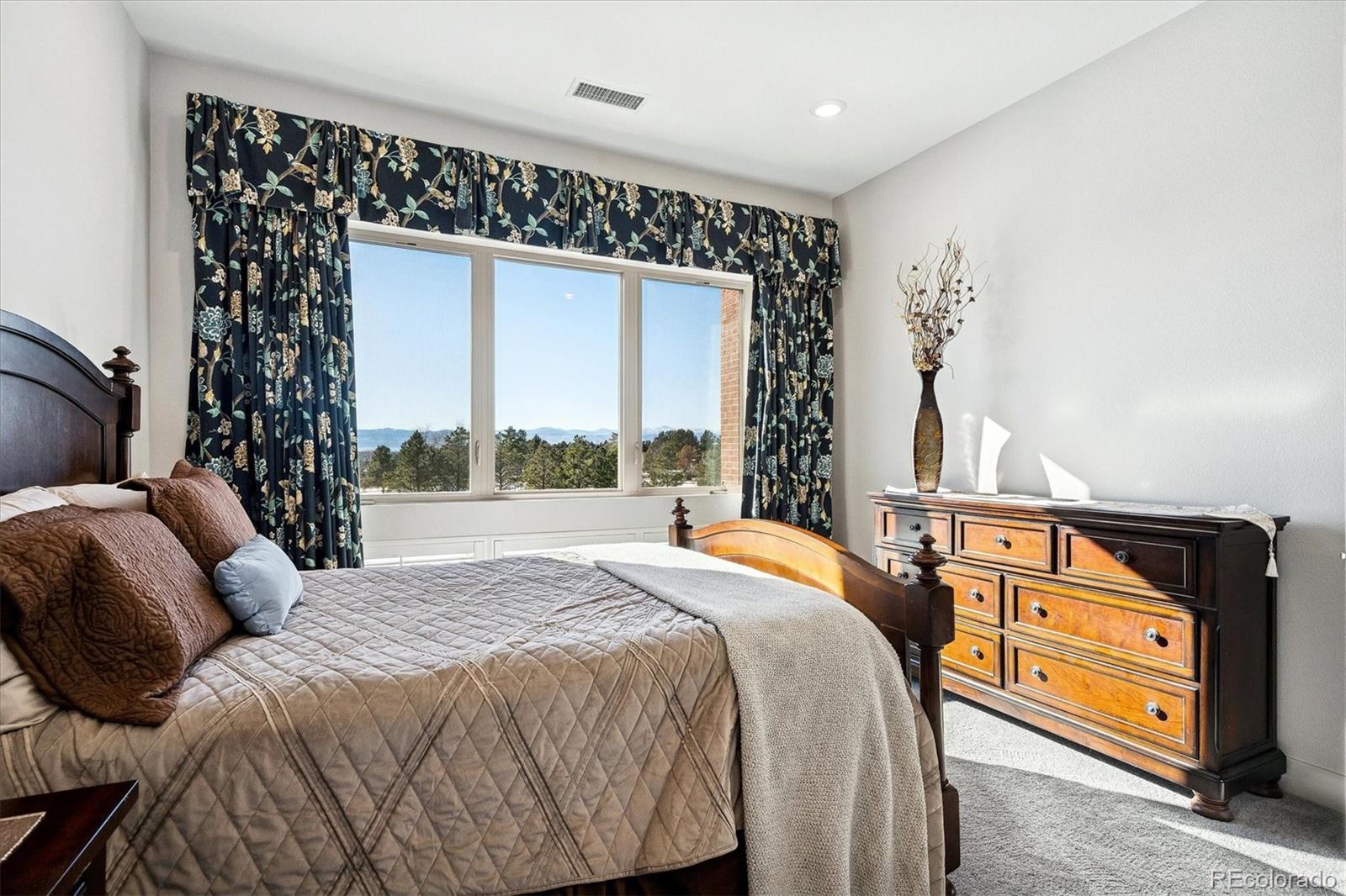 4885 South Monaco Street, Unit 207 Denver, CO 80237 - Photo 22 of 33 a bedroom with a bed and a window