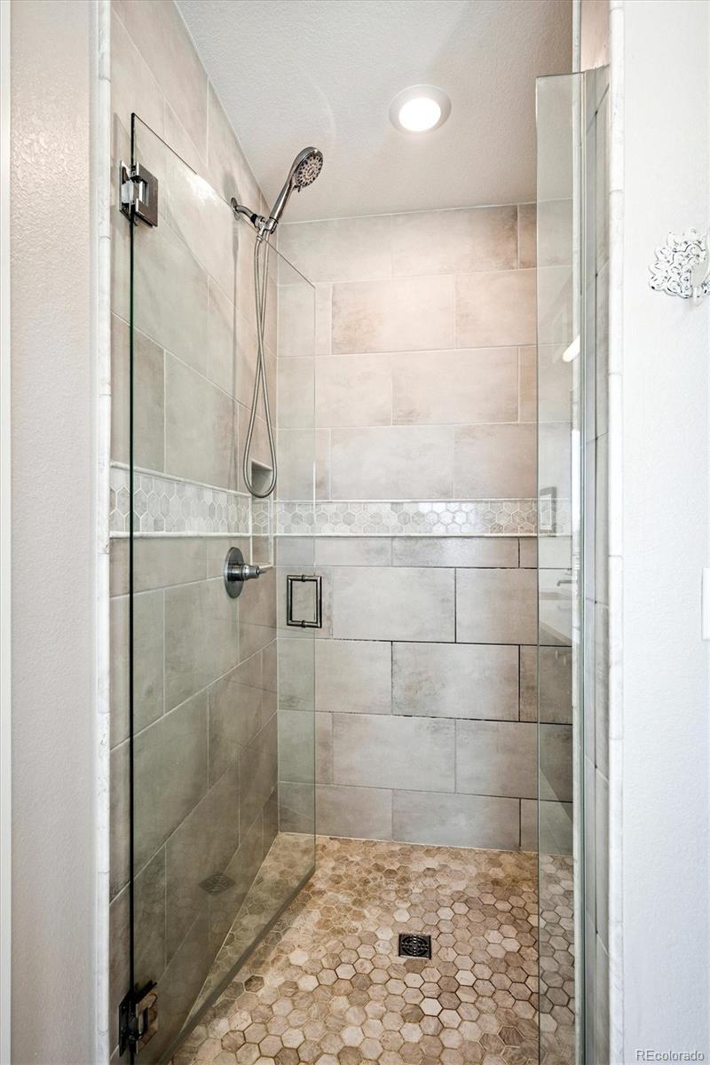4885 South Monaco Street, Unit 207 Denver, CO 80237 - Photo 25 of 33 a bathroom with a shower