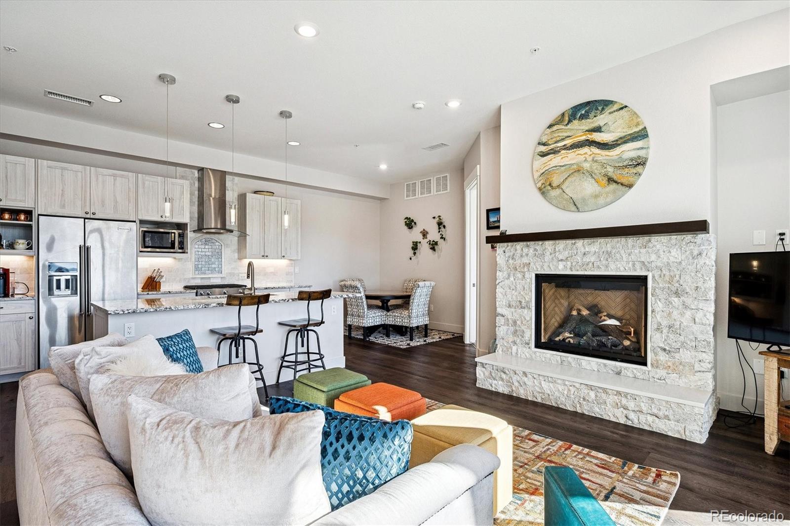 4885 South Monaco Street, Unit 207 Denver, CO 80237 - Photo 3 of 33 a living room with fireplace furniture and a fireplace