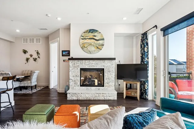 a living room with furniture a fireplace and a flat screen tv
