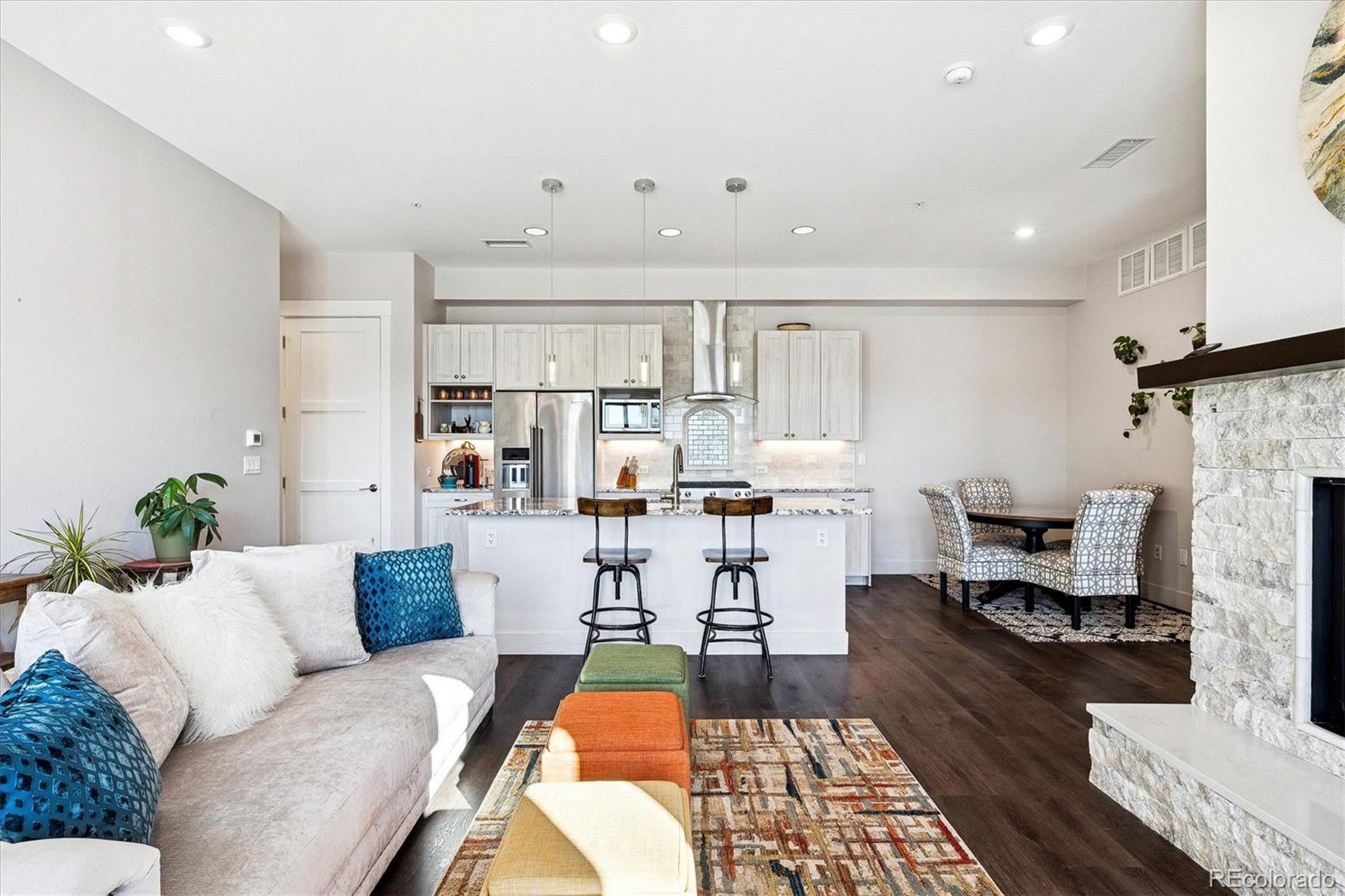4885 South Monaco Street, Unit 207 Denver, CO 80237 - Photo 5 of 33 a living room with furniture and a fireplace