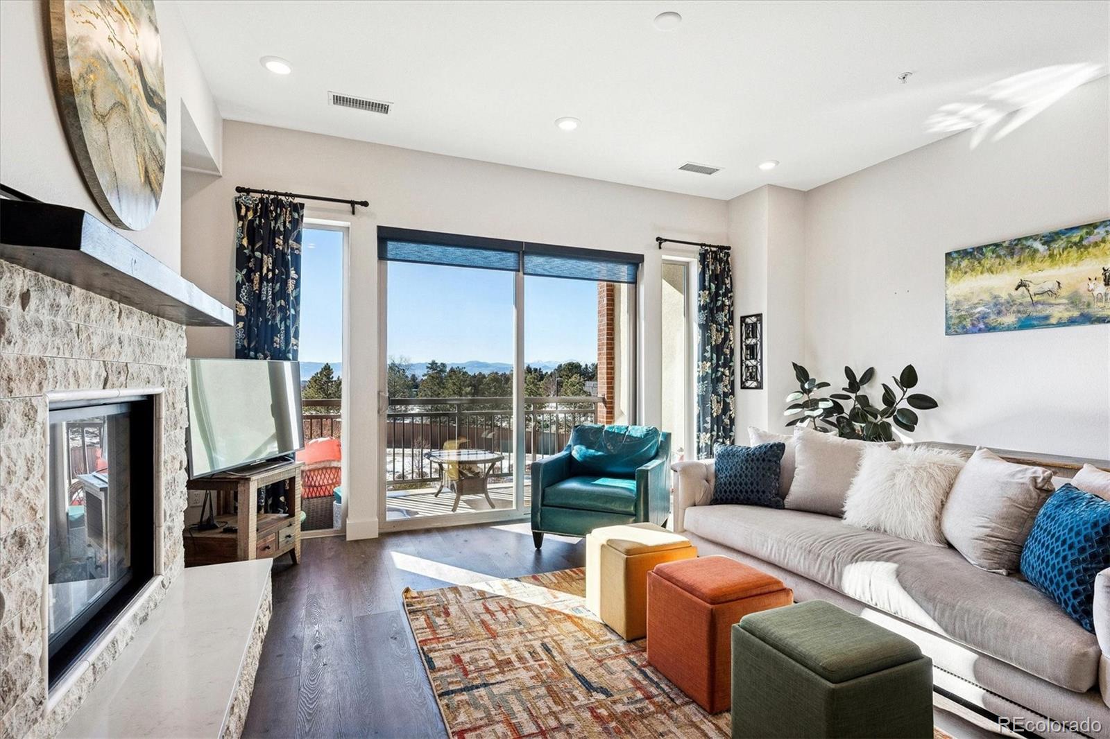 4885 South Monaco Street, Unit 207 Denver, CO 80237 - Photo 7 of 33 a living room with furniture fireplace and a flat screen tv