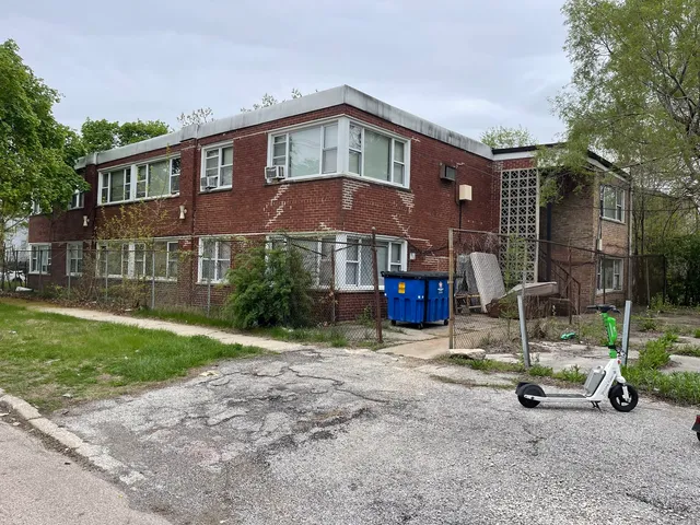 a view of a brick house with a patio
