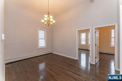 a view of a room with wooden floor and a window