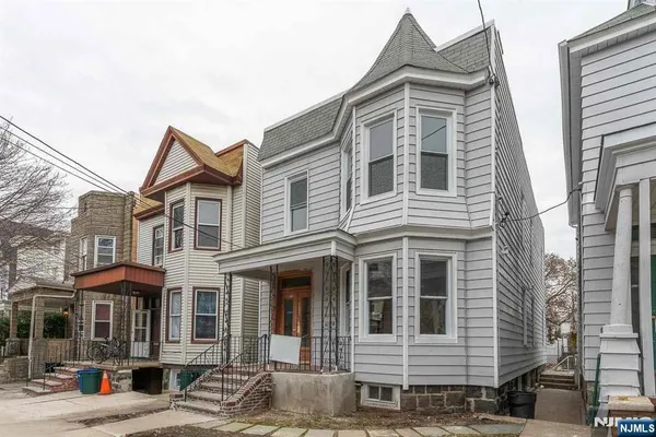a front view of a residential apartment building with a yard