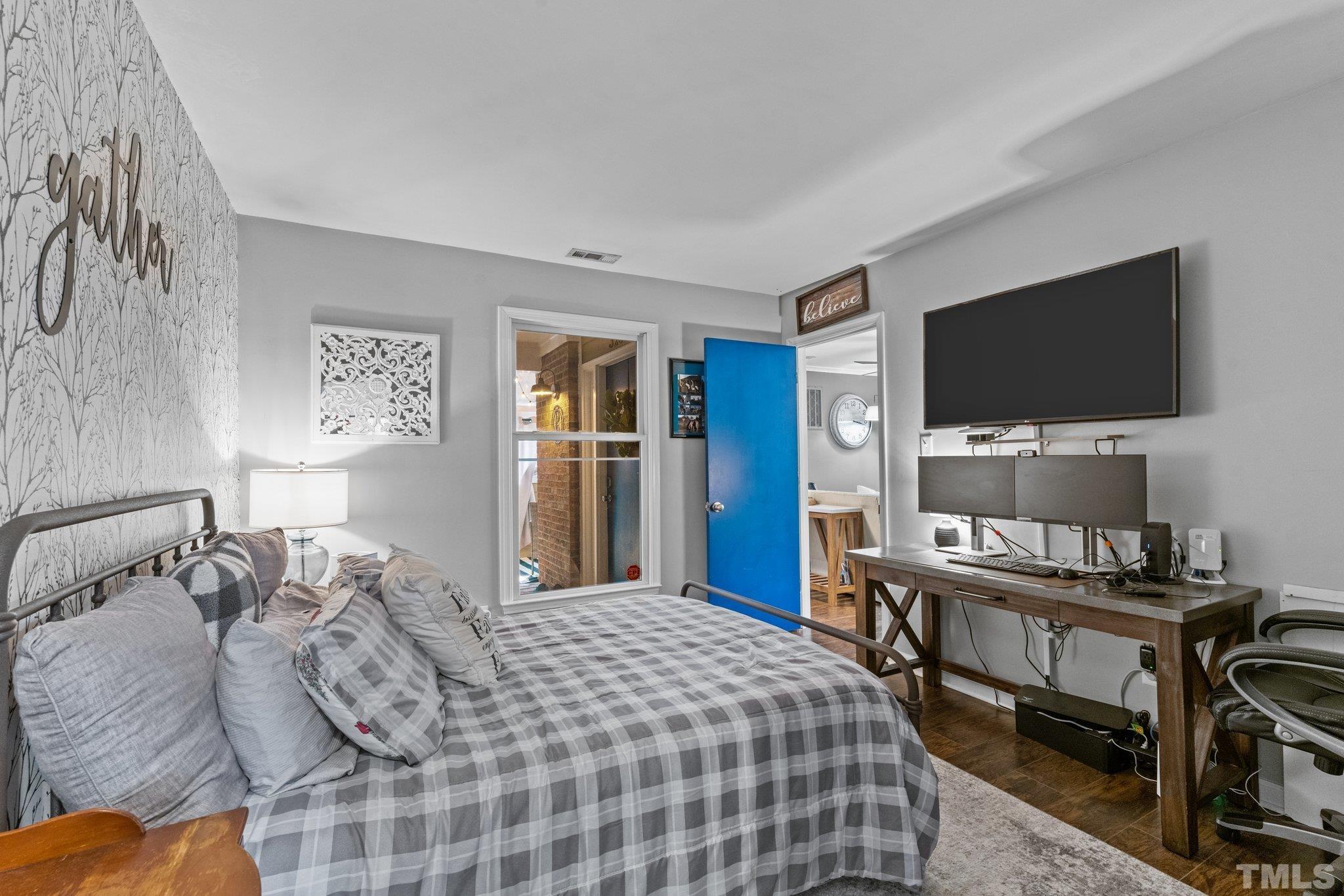 3231 Mill Run, Unit 3231 Raleigh, NC 27612 - Photo 11 of 28 a bedroom with a bed and a flat screen tv