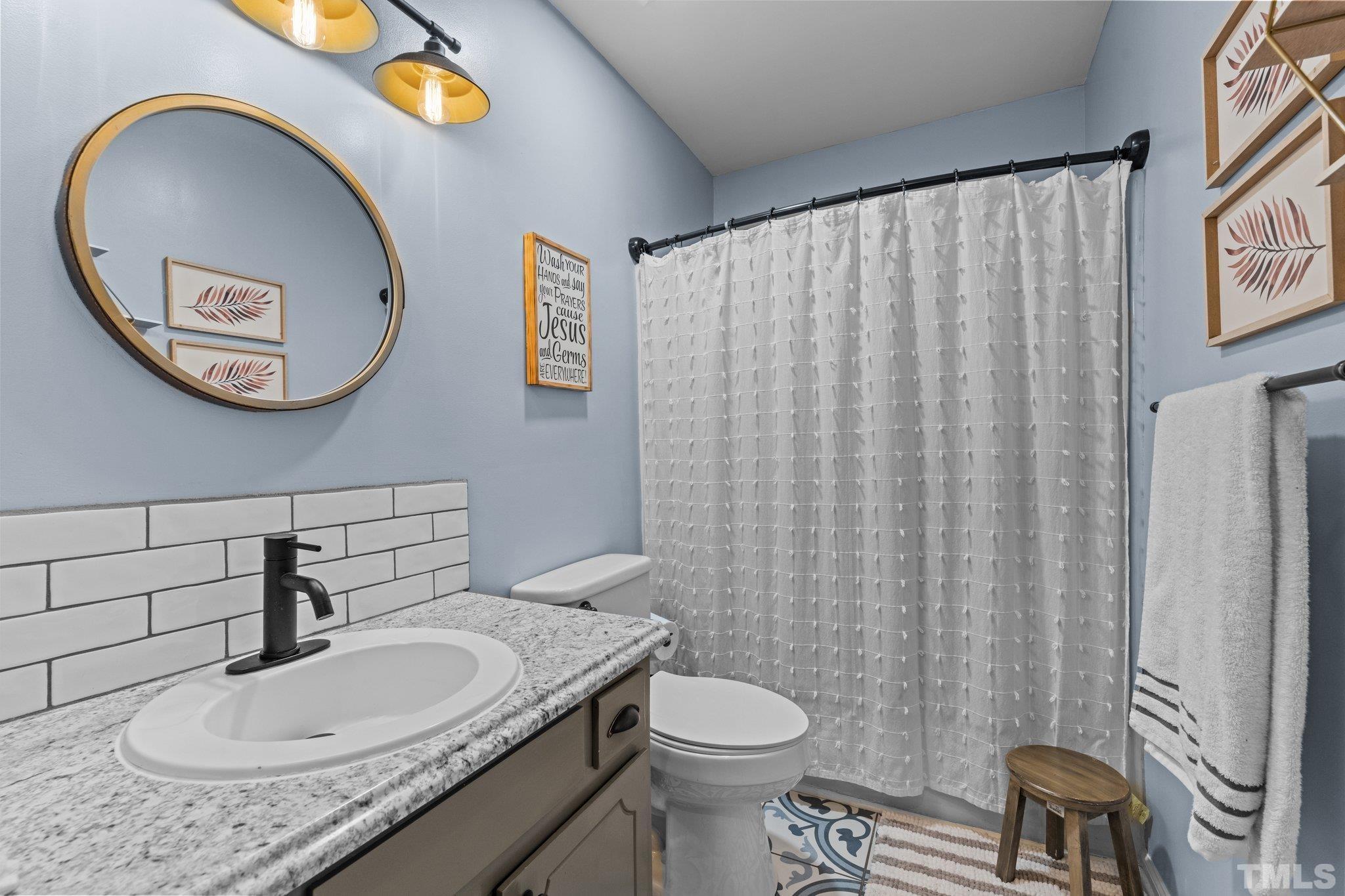 3231 Mill Run, Unit 3231 Raleigh, NC 27612 - Photo 13 of 28 a bathroom with a granite countertop sink and a mirror