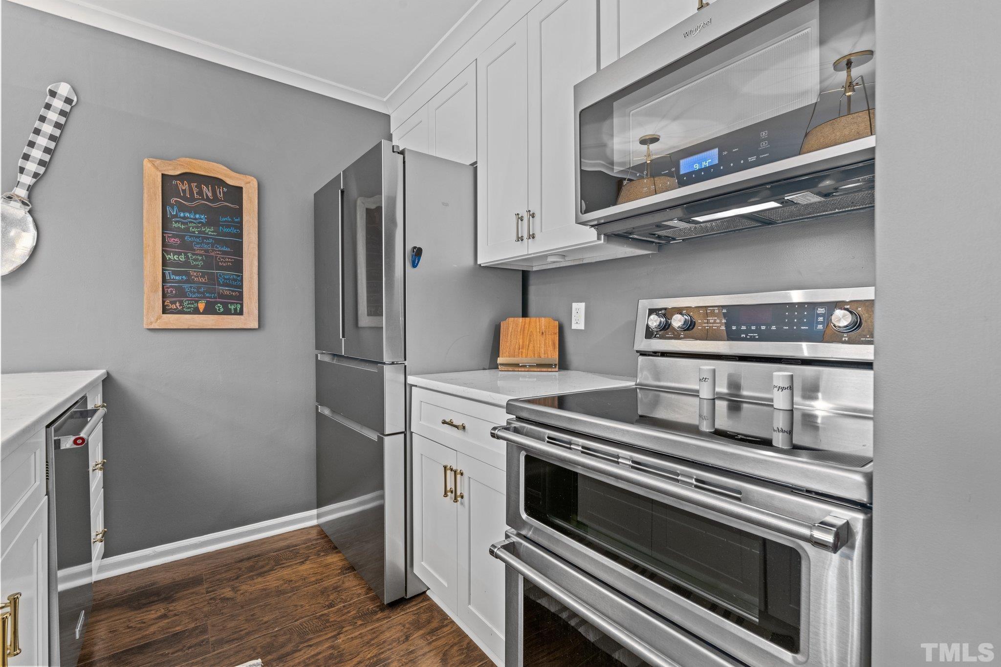 3231 Mill Run, Unit 3231 Raleigh, NC 27612 - Photo 15 of 28 a kitchen with stainless steel appliances granite countertop a stove and a refrigerator