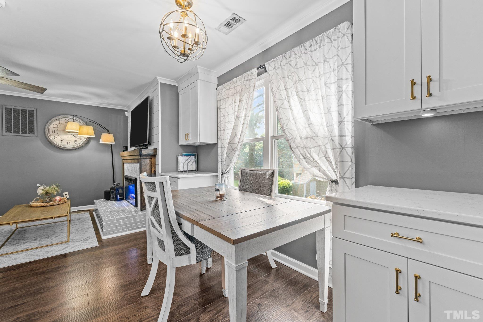 3231 Mill Run, Unit 3231 Raleigh, NC 27612 - Photo 17 of 28 a view of a dining room with furniture window and wooden floor