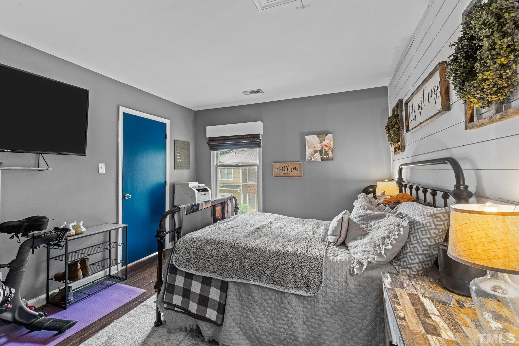 3231 Mill Run, Unit 3231 Raleigh, NC 27612 - Photo 18 of 28 a bedroom with a bed and a flat screen tv