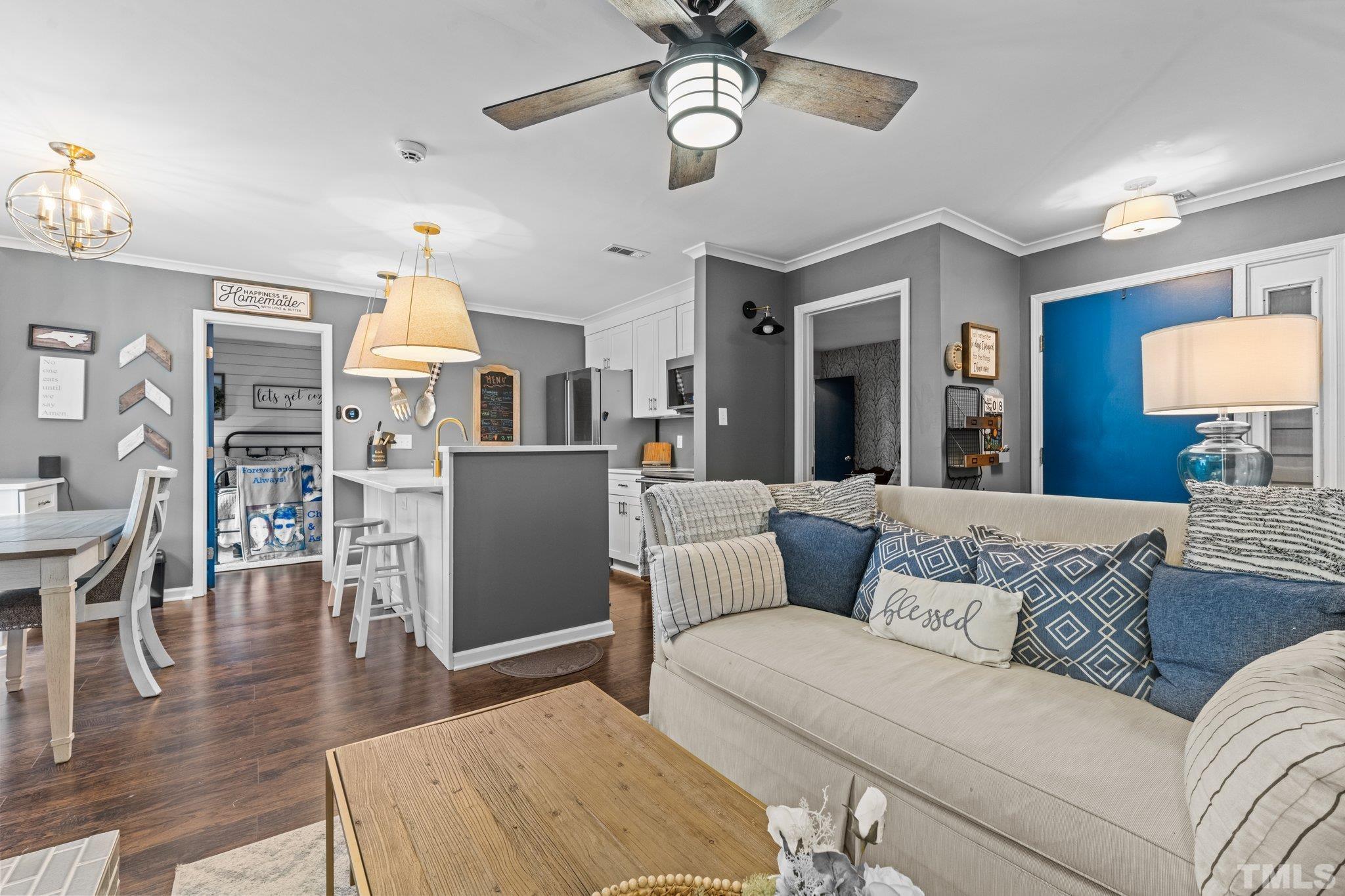 3231 Mill Run, Unit 3231 Raleigh, NC 27612 - Photo 22 of 28 a living room with furniture and a wooden floor