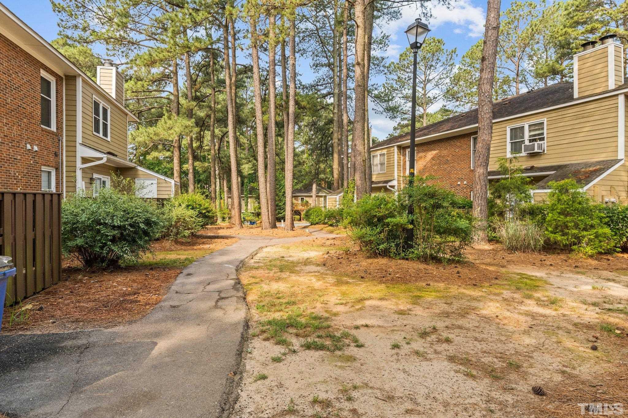 3231 Mill Run, Unit 3231 Raleigh, NC 27612 - Photo 25 of 28 a view of a brick house with a large trees