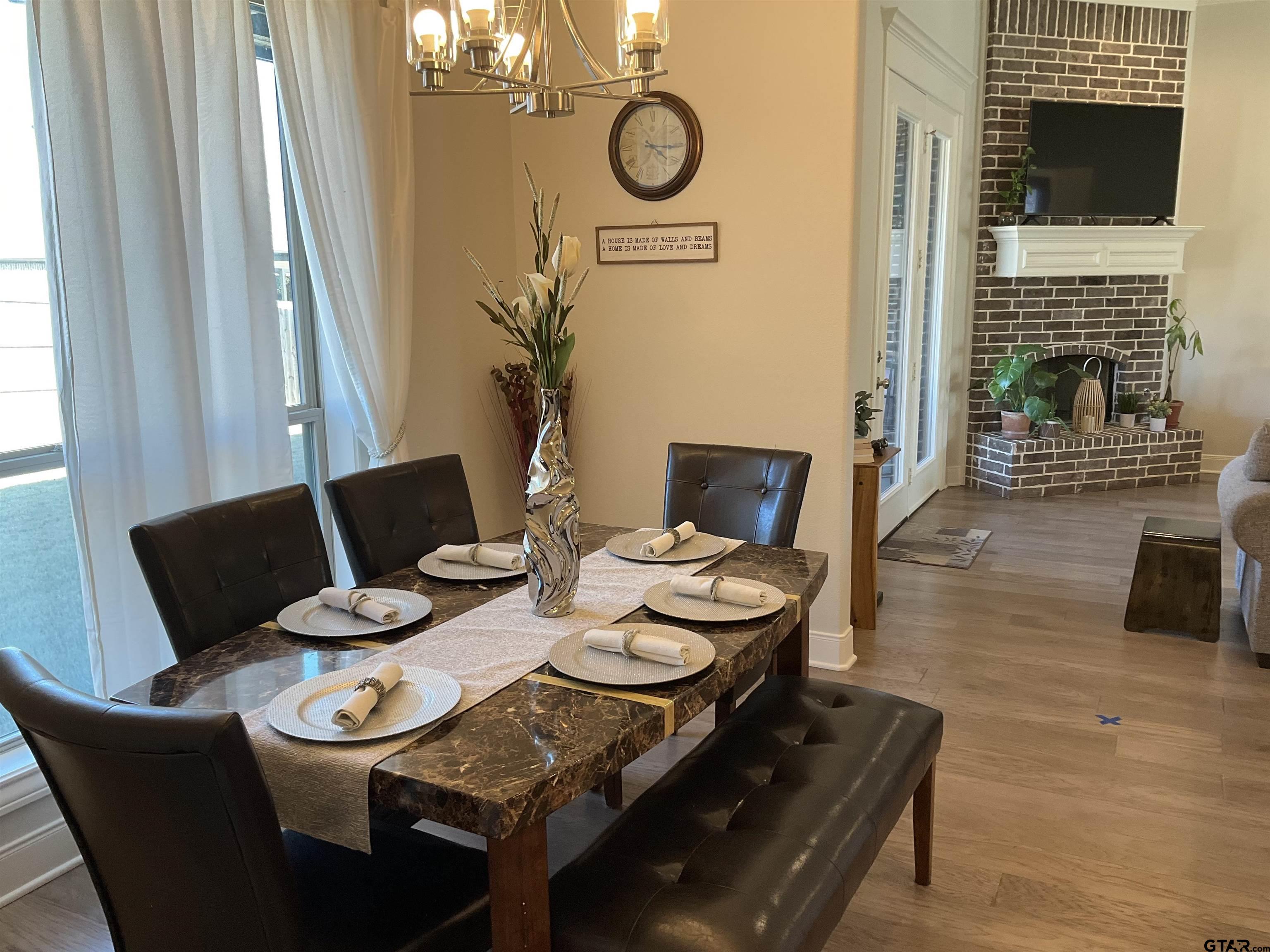 11978 Gillian Court Tyler, TX 75703 - Photo 12 of 36 a view of a dining room with furniture window and wooden floor